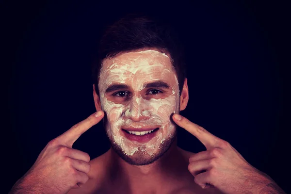 Man with cream moisturizer on his face. — Stock Photo, Image