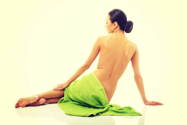 Back view woman sitting wrapped in towel — Stock Photo, Image