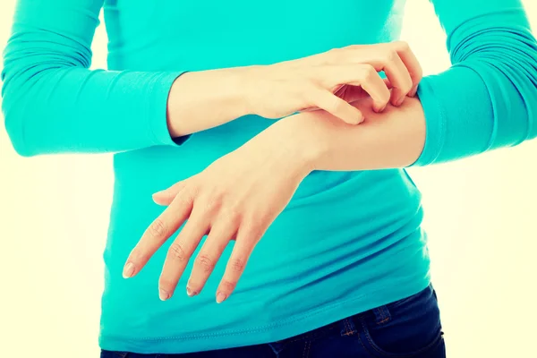 Young beautiful woman scratching herself — Stock Photo, Image