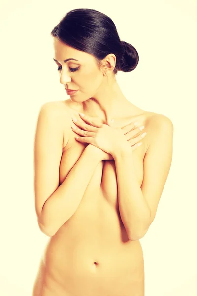 Widok z przodu nagie kobiety przekraczania jej ręce na klatce piersiowej — Zdjęcie stockowe