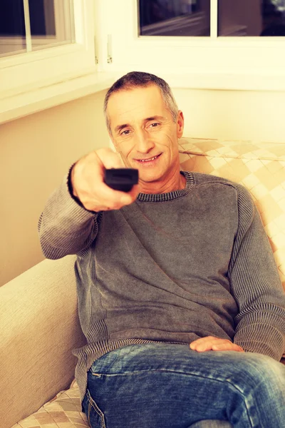Mature man with remote control — Stock Photo, Image
