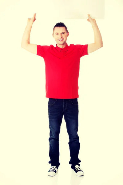 Happy man showing and displaying placard — Stock Photo, Image