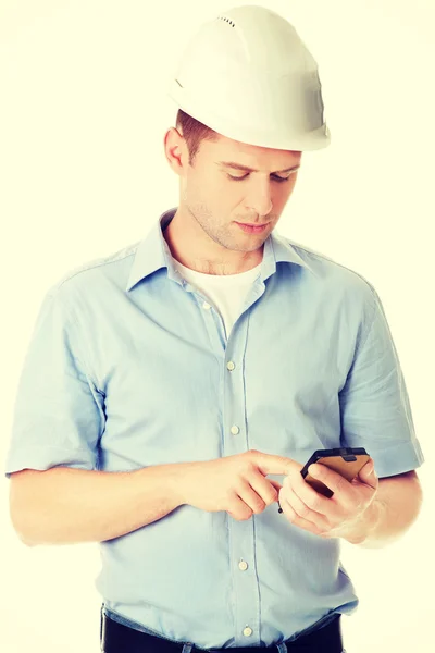 Contractor in hardhat using his cell phone — Stock Photo, Image