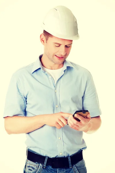 Contractor in hardhat using his cell phone — Stock Photo, Image