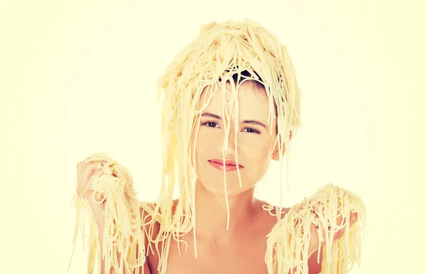 Beautiful woman with noodles on her head — Stock Photo, Image