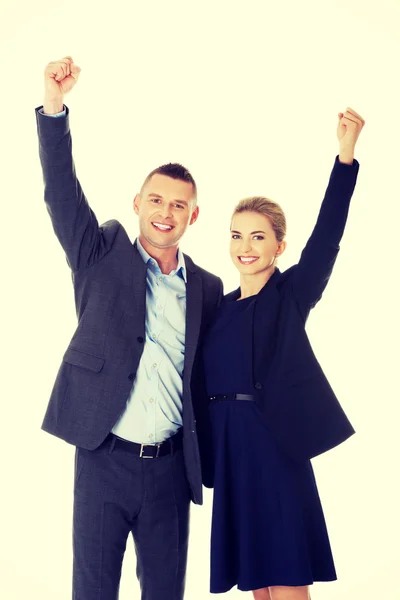 Victorious business couple with hands up — Stock Photo, Image