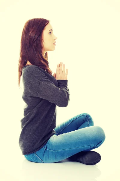 Pretty student girl meditating in lotus pose. — Stock Photo, Image