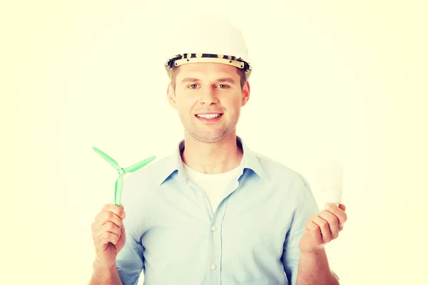 Man with a wind turbine and a light bulb. — Stock Photo, Image