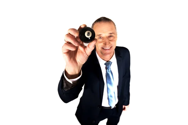 Businessman holding black billiard ball — Stock Photo, Image