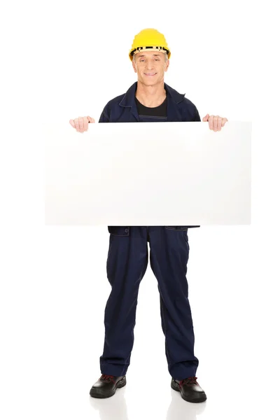 Full length happy worker presenting empty banner — Stock Photo, Image