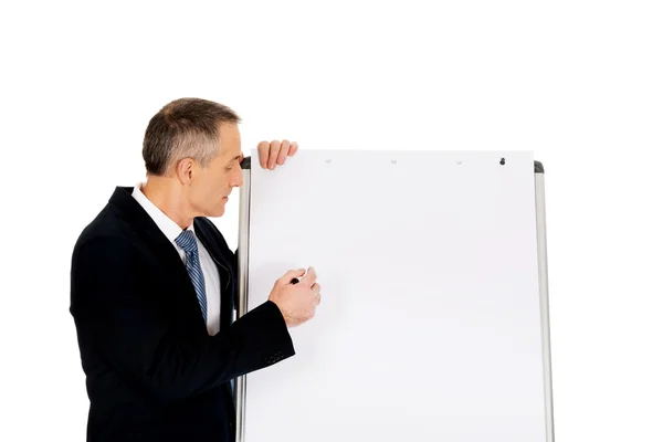 Escrita executiva masculina em um flipchart — Fotografia de Stock