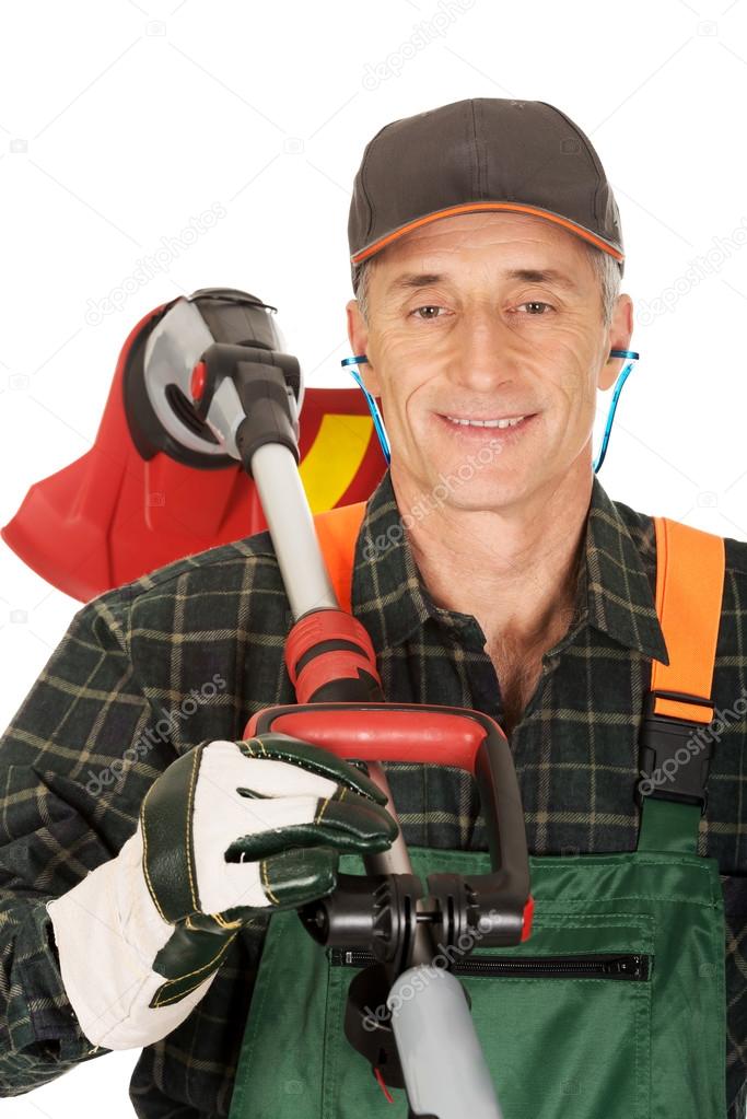 Gardener with trimmer and ear protectors
