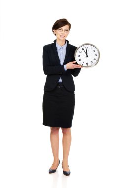 Businesswoman holding clock in hands.