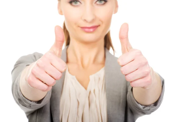Smiling businesswoman with thumbs up. Royalty Free Stock Images