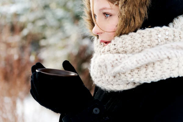 Woman holding hot drink — Stock Photo, Image