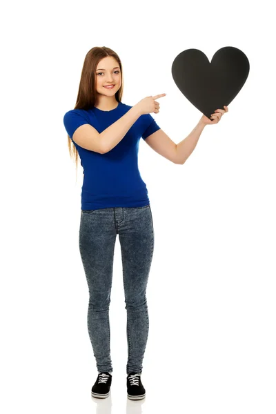 Happy teenager pointing on paper heart. — Stock Photo, Image