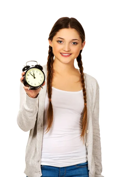 Happy teenage woman with alarm clock. — Stock Photo, Image