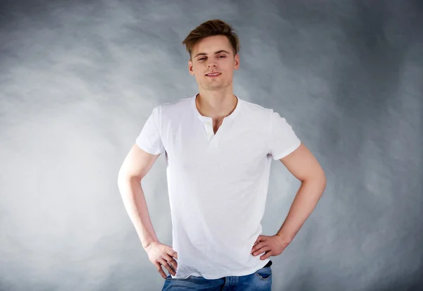 Young man with hands on hips. — Stock Photo, Image