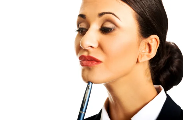 Задумчивая деловая женщина с ручкой — стоковое фото