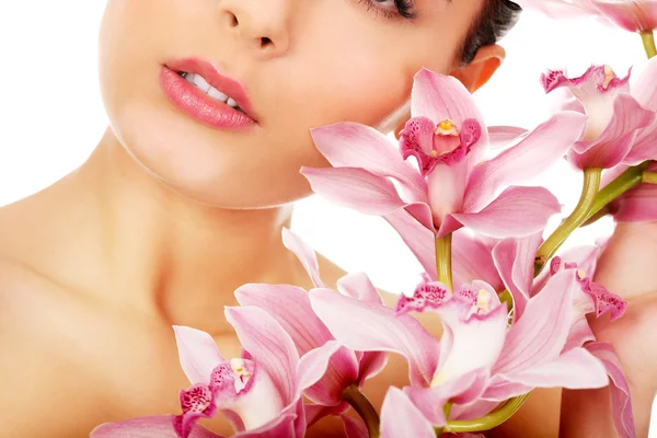 Beautiful woman with pink flower. Royalty Free Stock Images