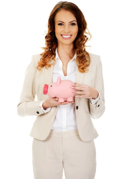 Businesswoman with a piggybank. — Stock Photo, Image