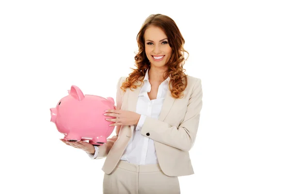 Business woman with a piggybank. — Stock Photo, Image