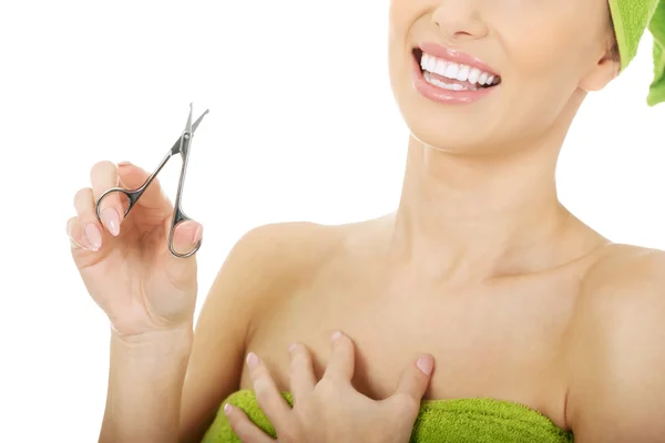Woman with a nail scissor. — Stock Photo, Image