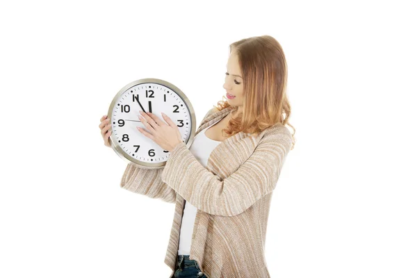 Woman changes clock leads. — Stock Photo, Image