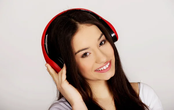 Rock woman with headphones listening to music. — Stock Photo, Image