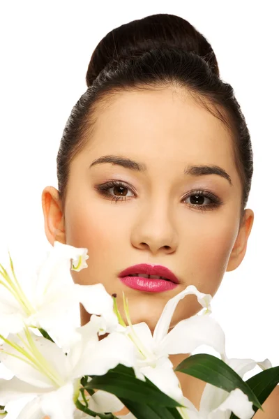 Beauty face of a woman with flower. — Stock Photo, Image