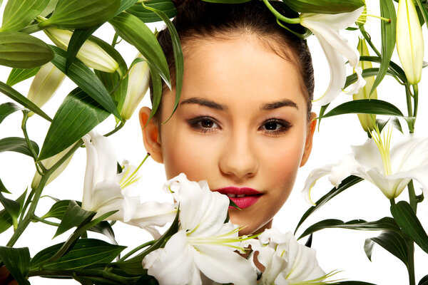 Beauty face of a woman with flowers.