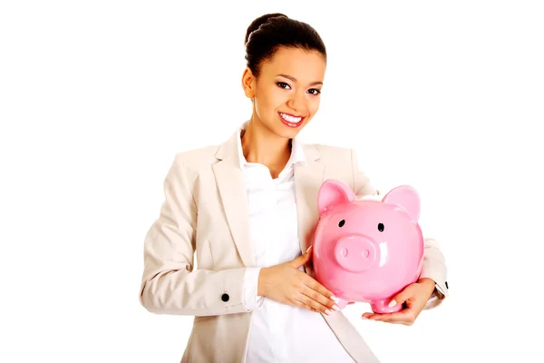 Business woman with a piggy bank. — Stock Photo, Image