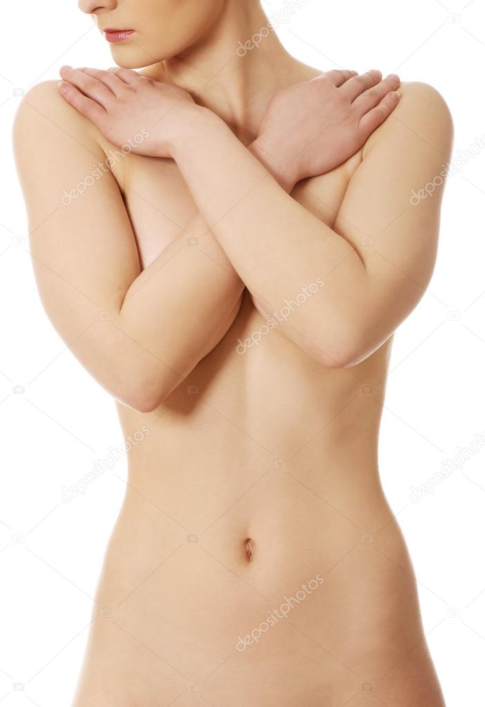 Topless woman covers her breast.