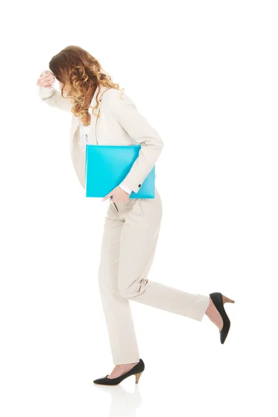 Tired businesswoman with binder. — Stock Photo, Image