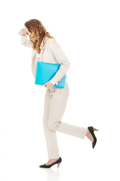 Tired businesswoman with binder. — Stock Photo, Image