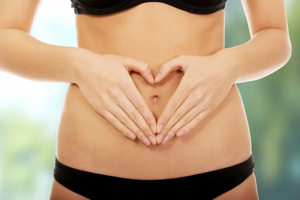 Woman with hands on belly. — Stock Photo, Image