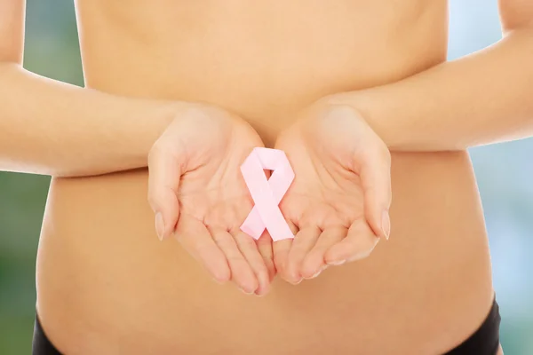 Female hands holding pink ribbon. — Stock Photo, Image