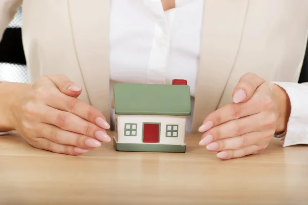 Businesswoman presenting a model house. Stock Image