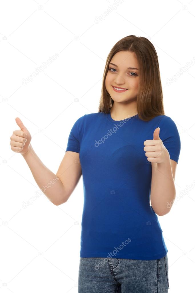 Happy female student showing thumbs up.