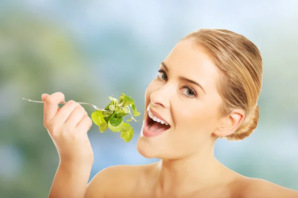 Nude woman eating lettuce — Stock Photo, Image