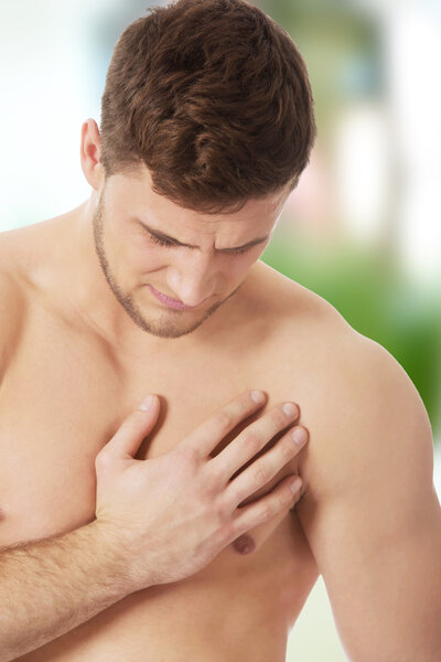 Athletic man feeling pain in his chest.
