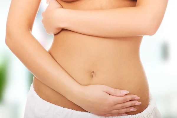 Woman cares about her belly. — Stock Photo, Image