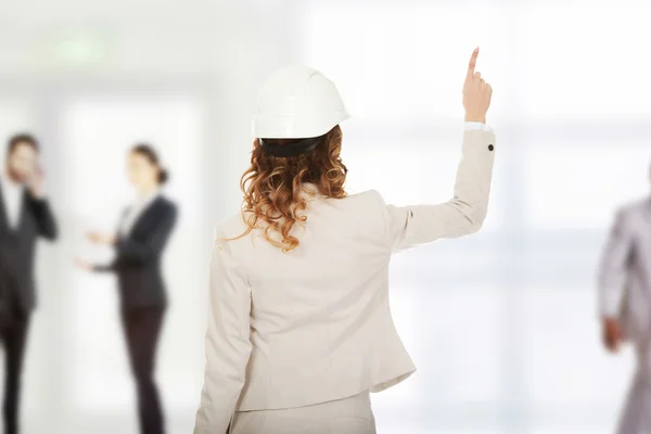 Mujer de negocios en casco blanco apuntando hacia arriba . —  Fotos de Stock