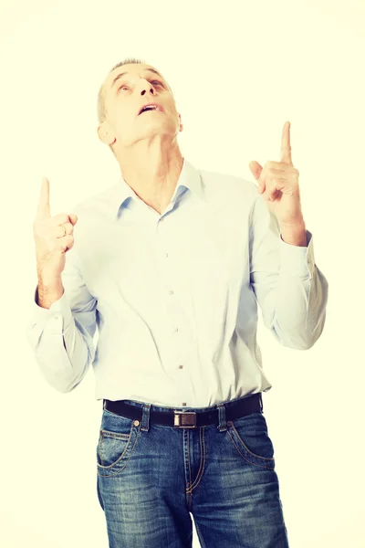 Happy handsome man pointing up — Stock Photo, Image
