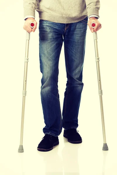 Male legs with crutches — Stock Photo, Image