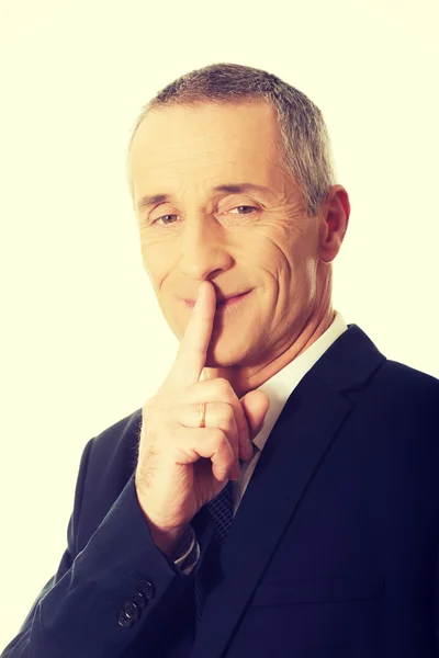 Businessman gesturing silent sign — Stock Photo, Image