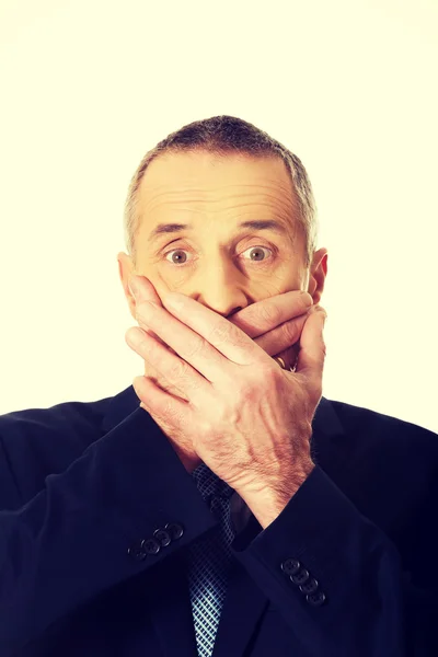 Businessman covering mouth — Stock Photo, Image