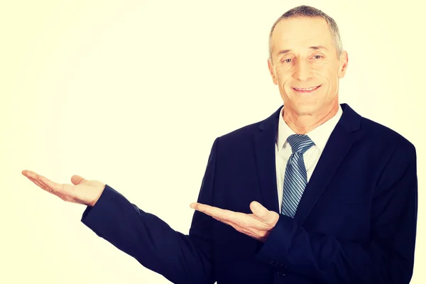 Businessman with welcome gesture — Stock Photo, Image
