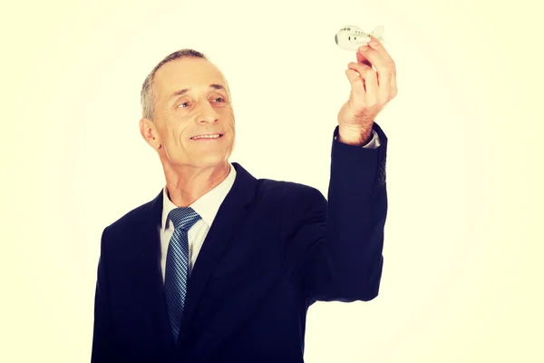 Businessman holding small airplane — Stock Photo, Image