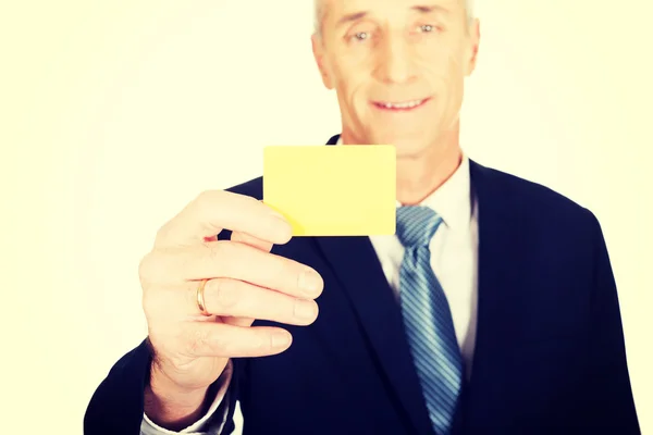 Businessman showing a yellow identity name card — Stock Photo, Image